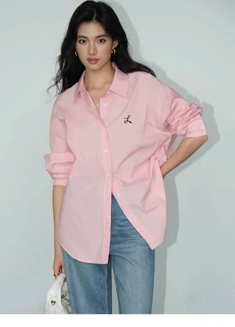 Soft pink oversized embroidered button-down shirt paired with light blue straight leg jeans