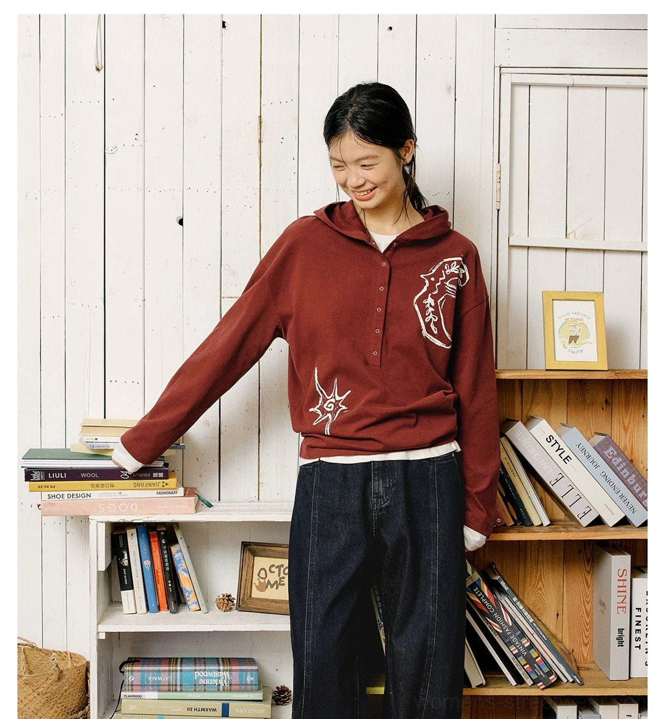 Oversized embroidered graphic Henley polo shirt showing its relaxed Korean streetwear silhouette and artistic cotton design