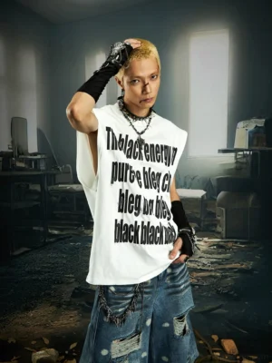 White oversized energy graphic muscle tee with stacked black lettering worn by male model with layered necklaces and distressed denim