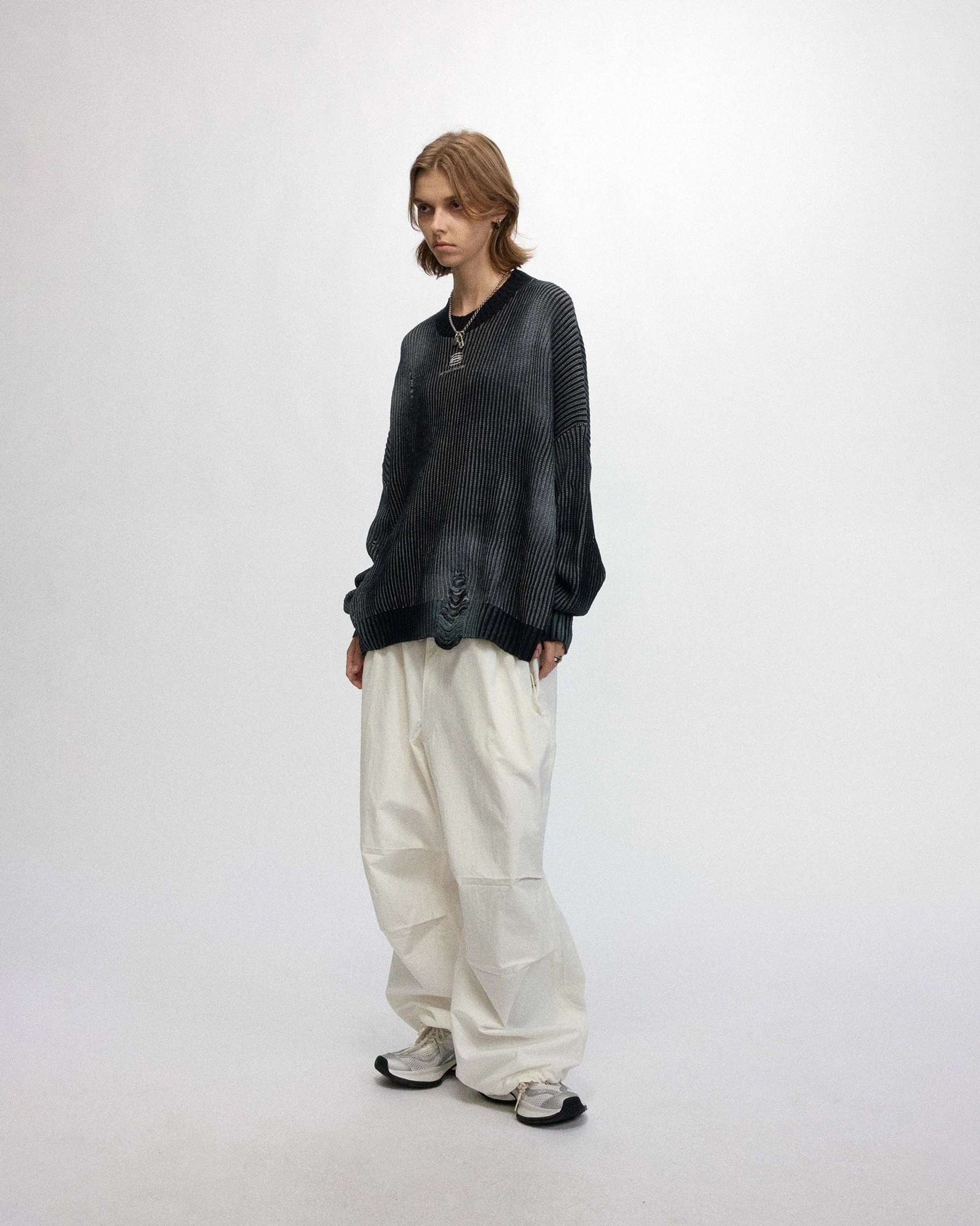 Oversized ribbed logo sweater in faded black with subtle distressed hem details and casual urban styling