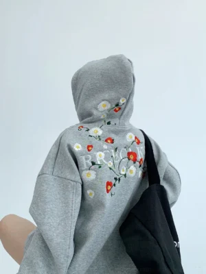 Heather grey oversized floral embroidered streetwear hoodie back view with botanical graphic detail