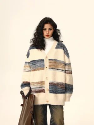 Oversized gradient striped mohair cardigan with V-neck button front styled with high-neck top wide-leg jeans and brown tote bag