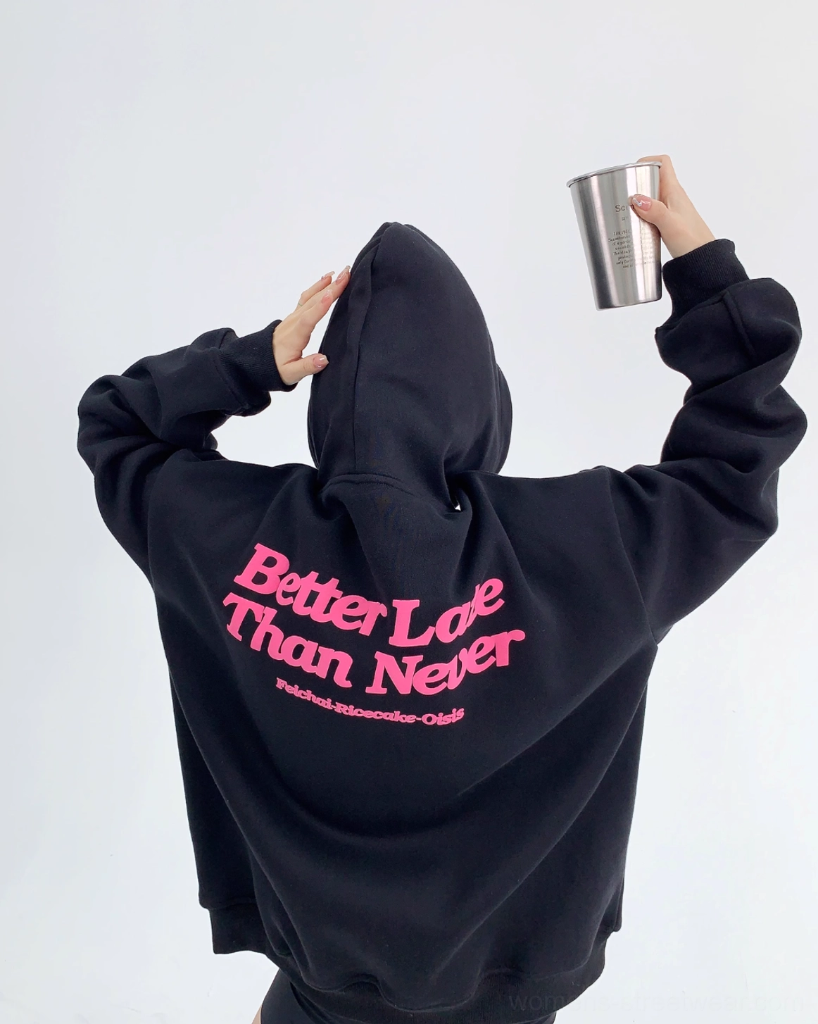Oversized graphic hoodie with pink back print and relaxed Korean streetwear silhouette in a casual urban styling view