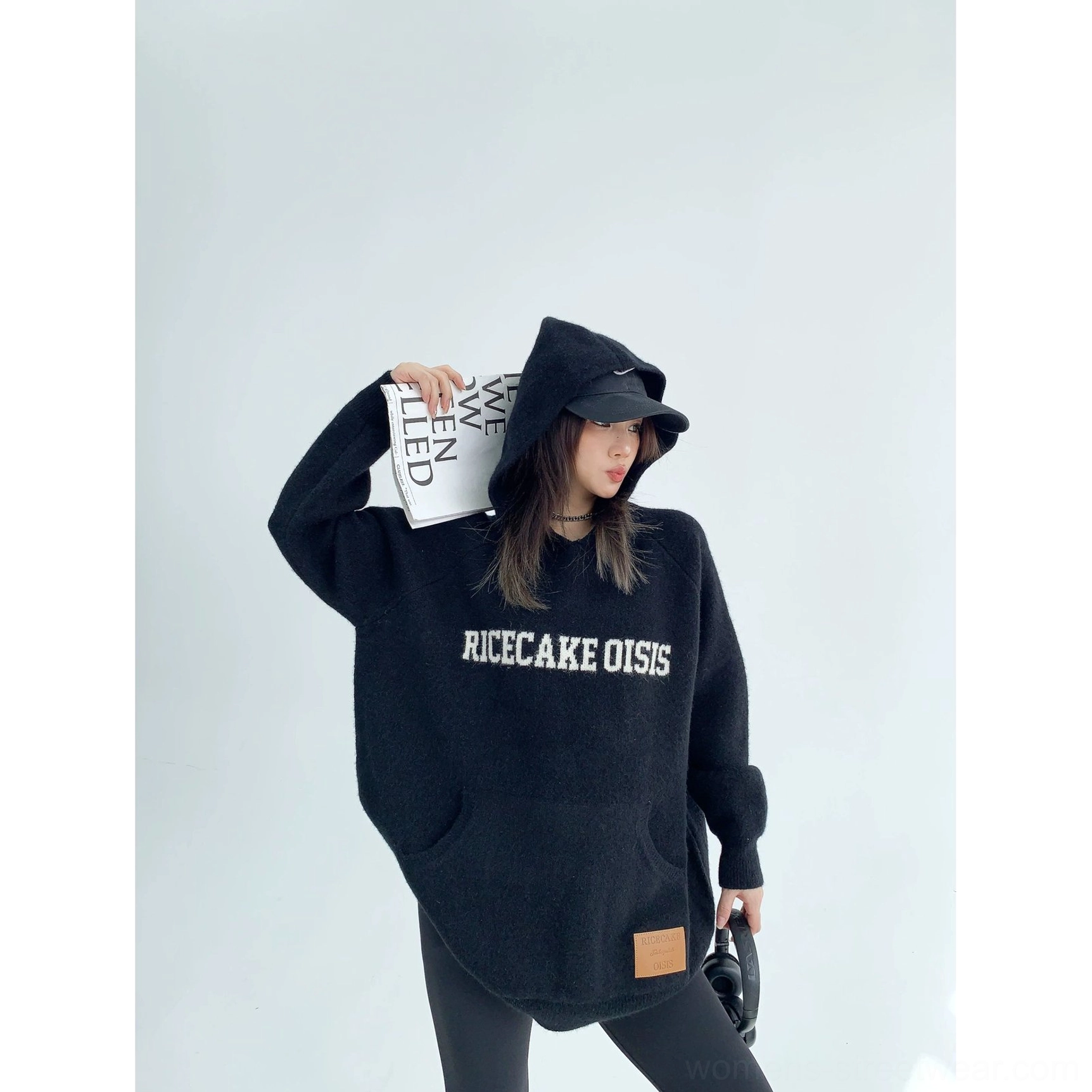Oversized graphic knit hoodie with cozy streetwear silhouette, contrast chest lettering, kangaroo pocket, and soft thick fabric