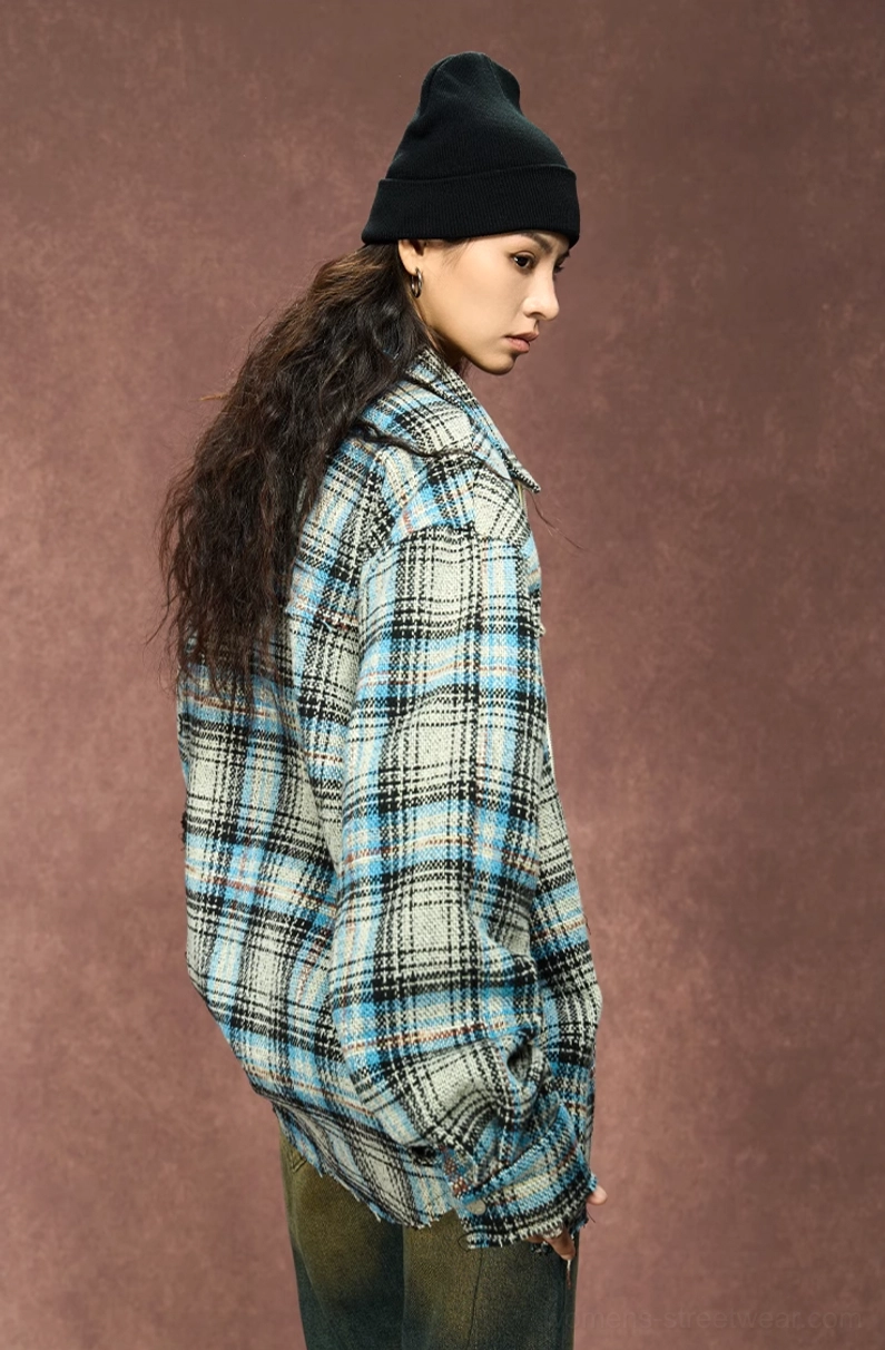 Side back view of female model in an oversized gray plaid shirt jacket with draped sleeves and relaxed streetwear silhouette