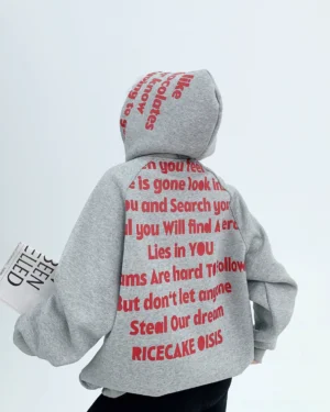 Rear view of oversized gray graphic hoodie with bold red script lettering printed across the raised hood and full back