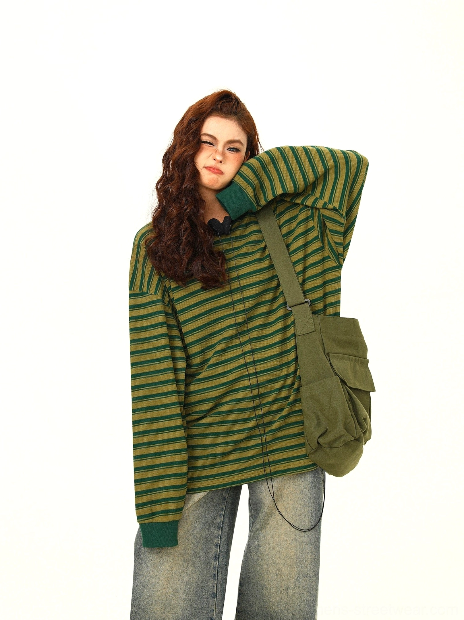 Oversized green yellow striped long sleeve streetwear tee showing long dropped sleeves and adjustable drawstring hem