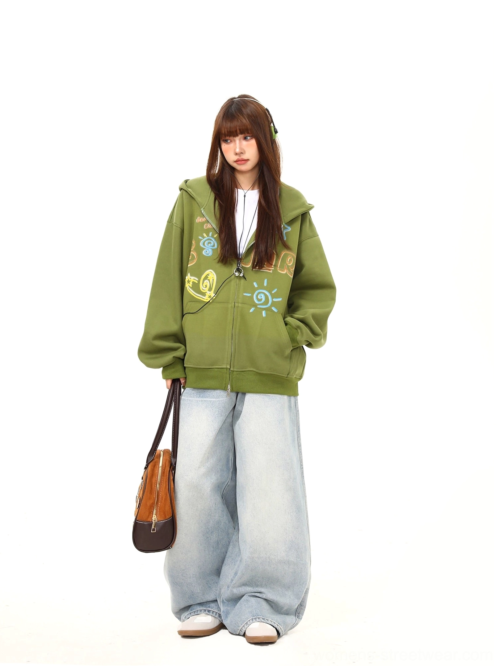 Side view of an oversized green zip-up hoodie with relaxed shoulders, decorative graffiti artwork, and casual Korean fashion styling