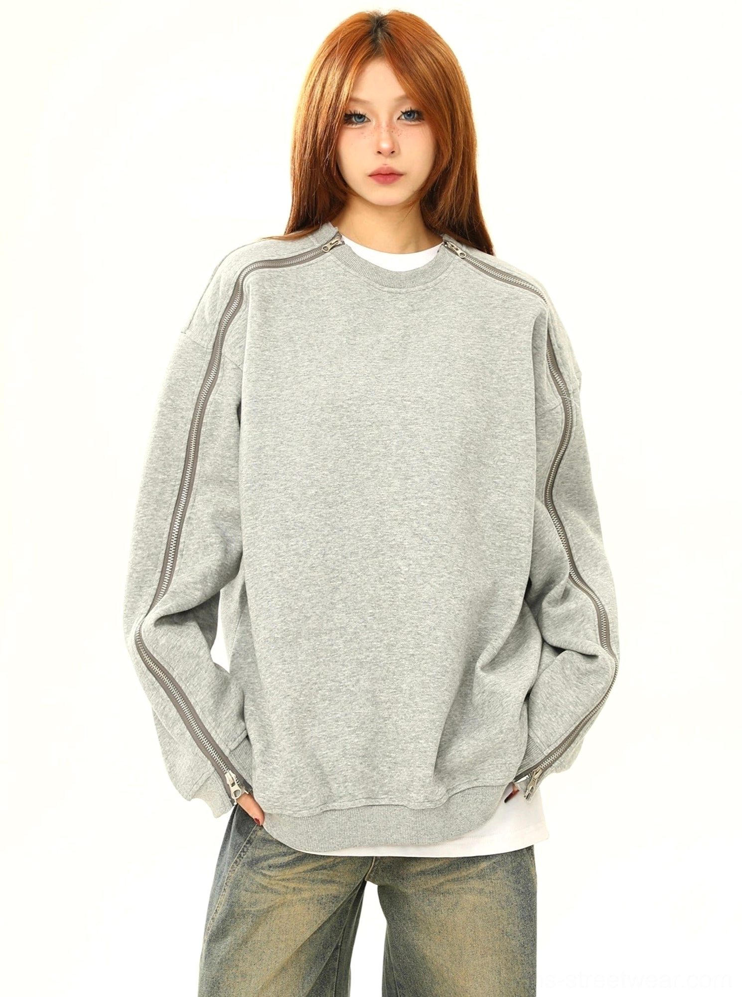 Oversized heather gray zip sleeve crewneck sweatshirt worn by female model in front view