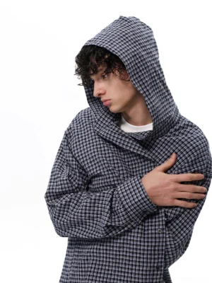 Oversized navy and white plaid hooded lounge shirt close-up showing dropped shoulders and textured woven fabric