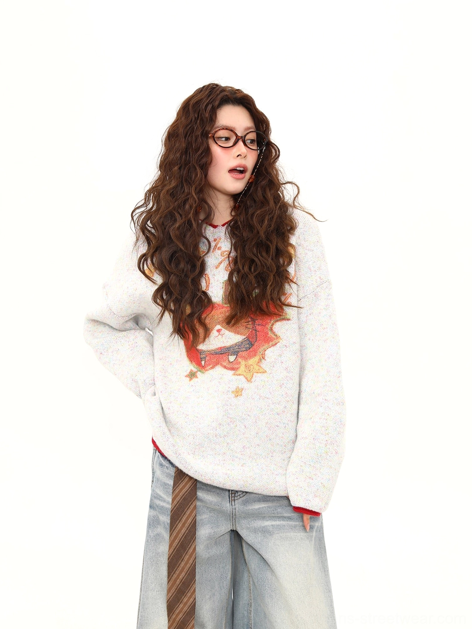 Side front view of the relaxed oversized kitty apple pie knit sweater with heathered texture and red cuffs