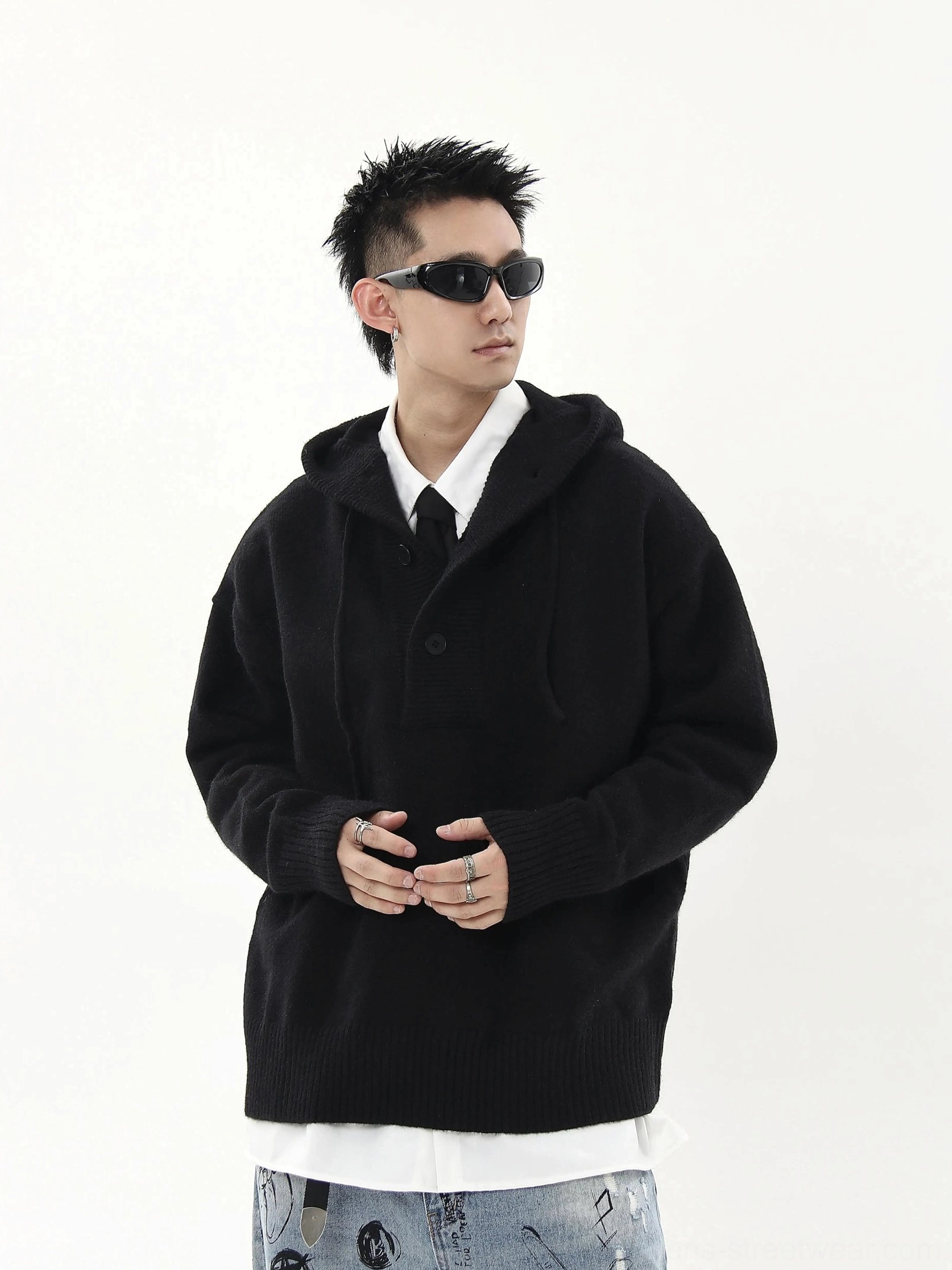 Black oversized knit half-button streetwear hoodie sweater styled with a white layered shirt and printed denim side view