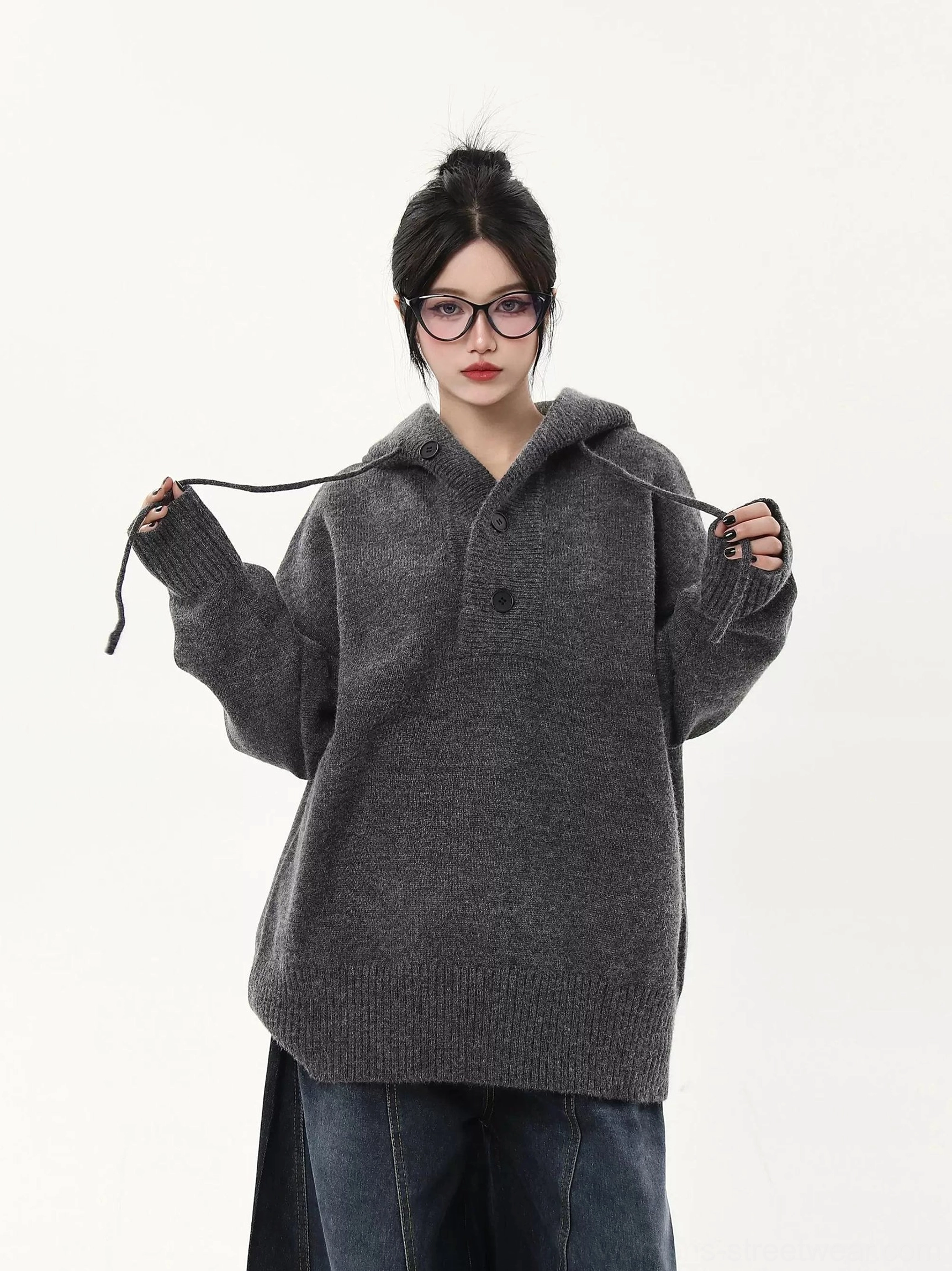 Heather gray oversized knit half-button hoodie sweater close-up showing soft knit texture, drawstring hood, and relaxed fit
