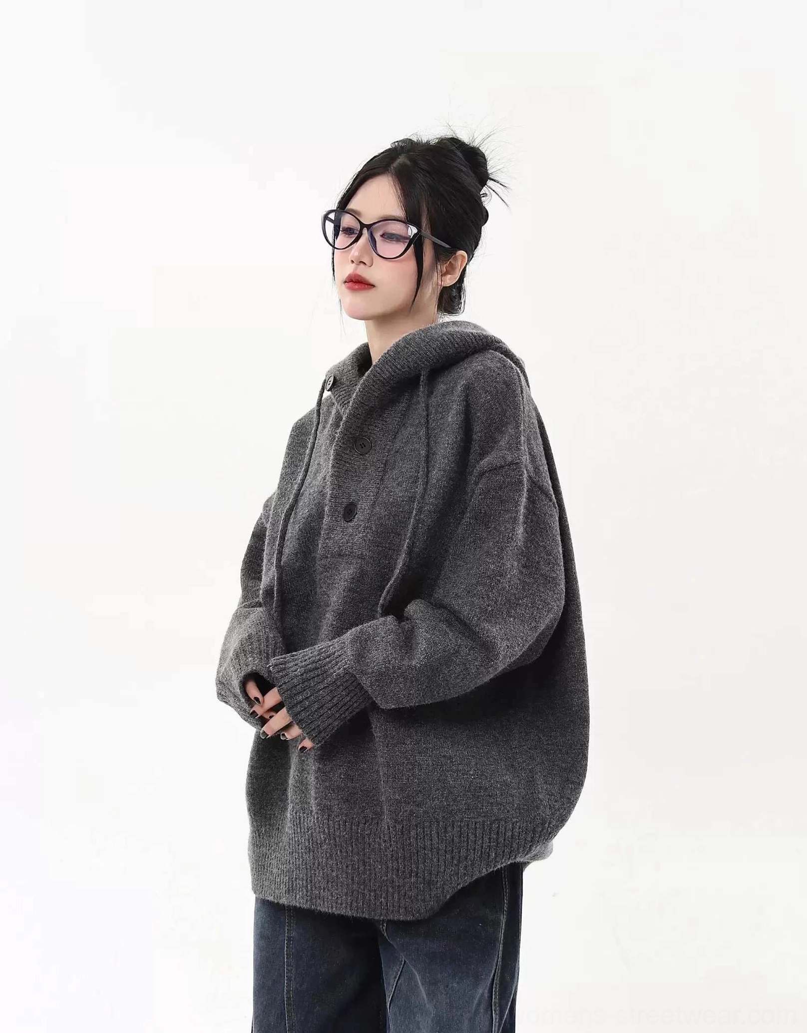 Gray oversized knit half-button streetwear hoodie sweater paired with wide-leg denim in a relaxed side outfit view