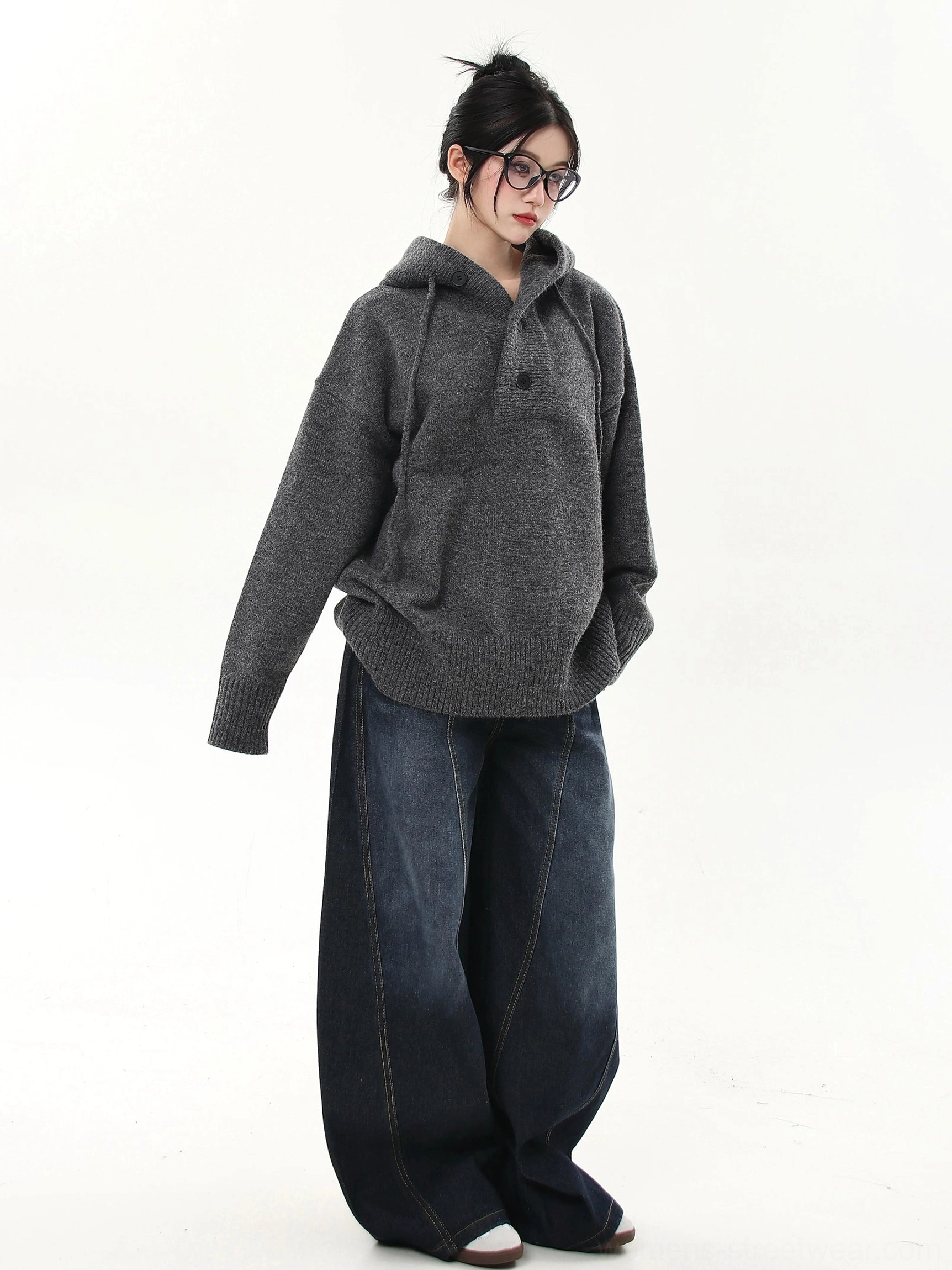Oversized knit half-button streetwear hoodie sweater detail image featuring the hood drawstrings and button neckline
