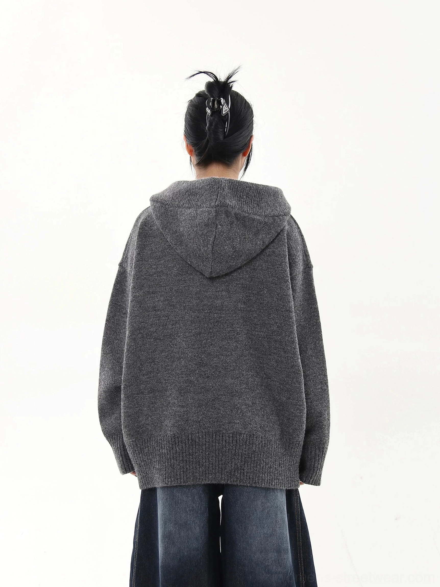 Oversized knit half-button streetwear hoodie sweater showcasing the loose unisex fit and textured knitted construction