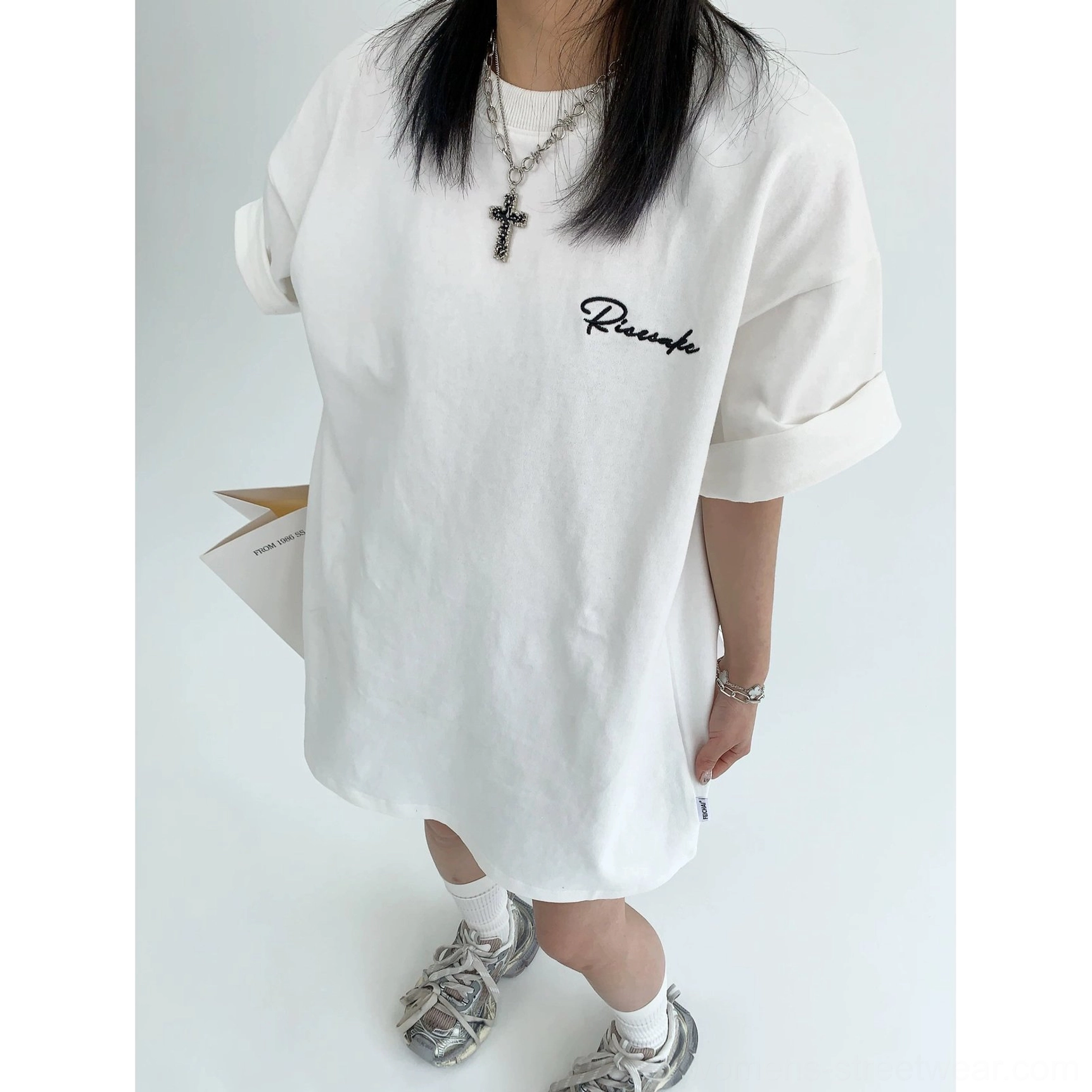 White oversized script T-shirt full body front view showing rolled short sleeves and relaxed boxy fit