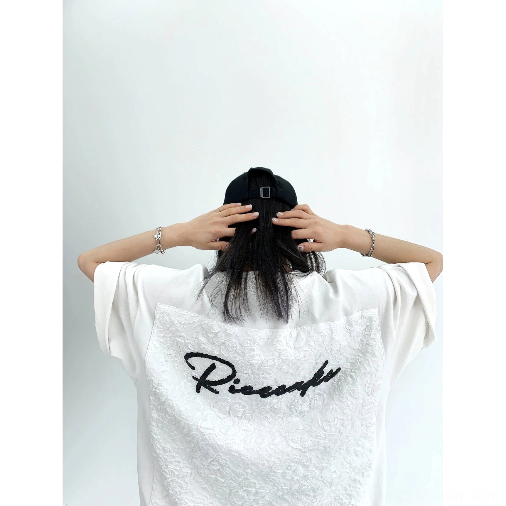 White oversized lace panel script streetwear tee product view featuring loose boxy silhouette and floral back detail