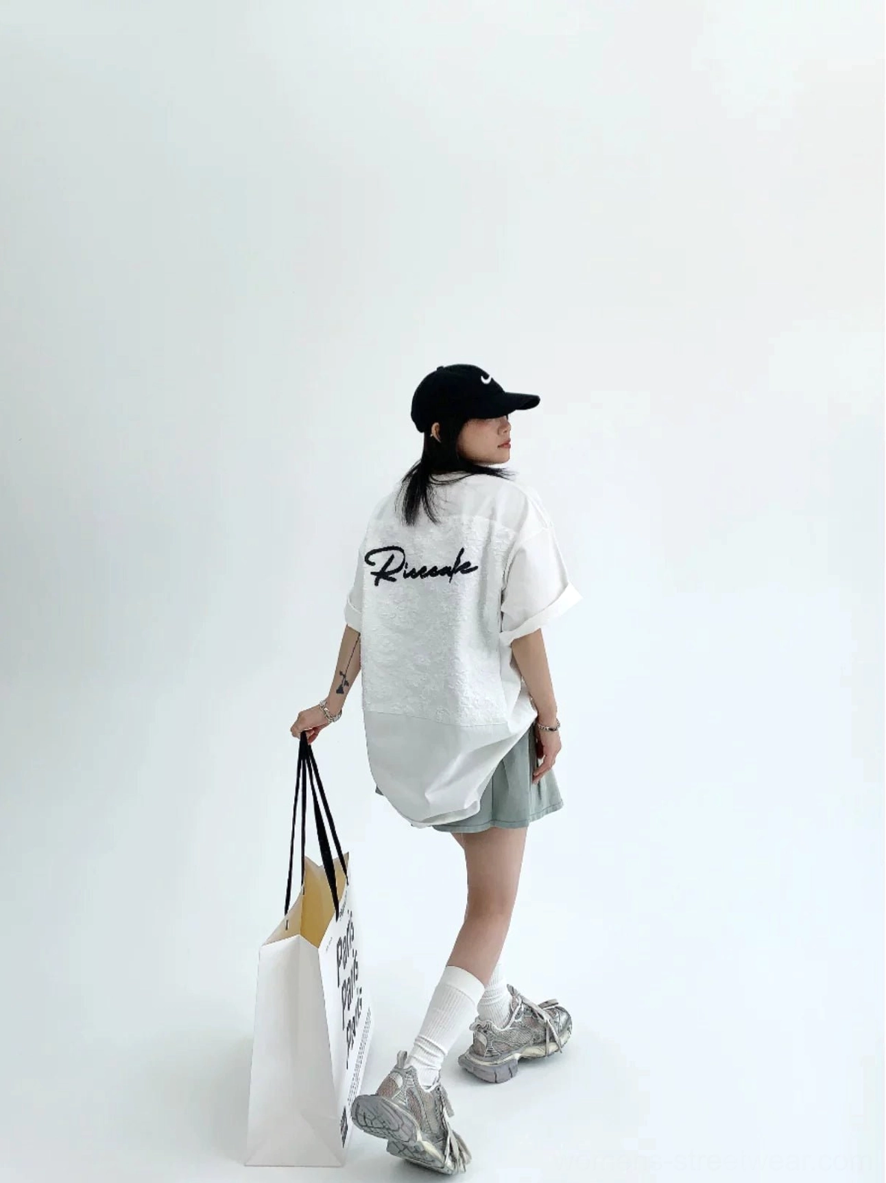 White oversized lace panel script tee side back outfit view with loose boxy Korean streetwear silhouette
