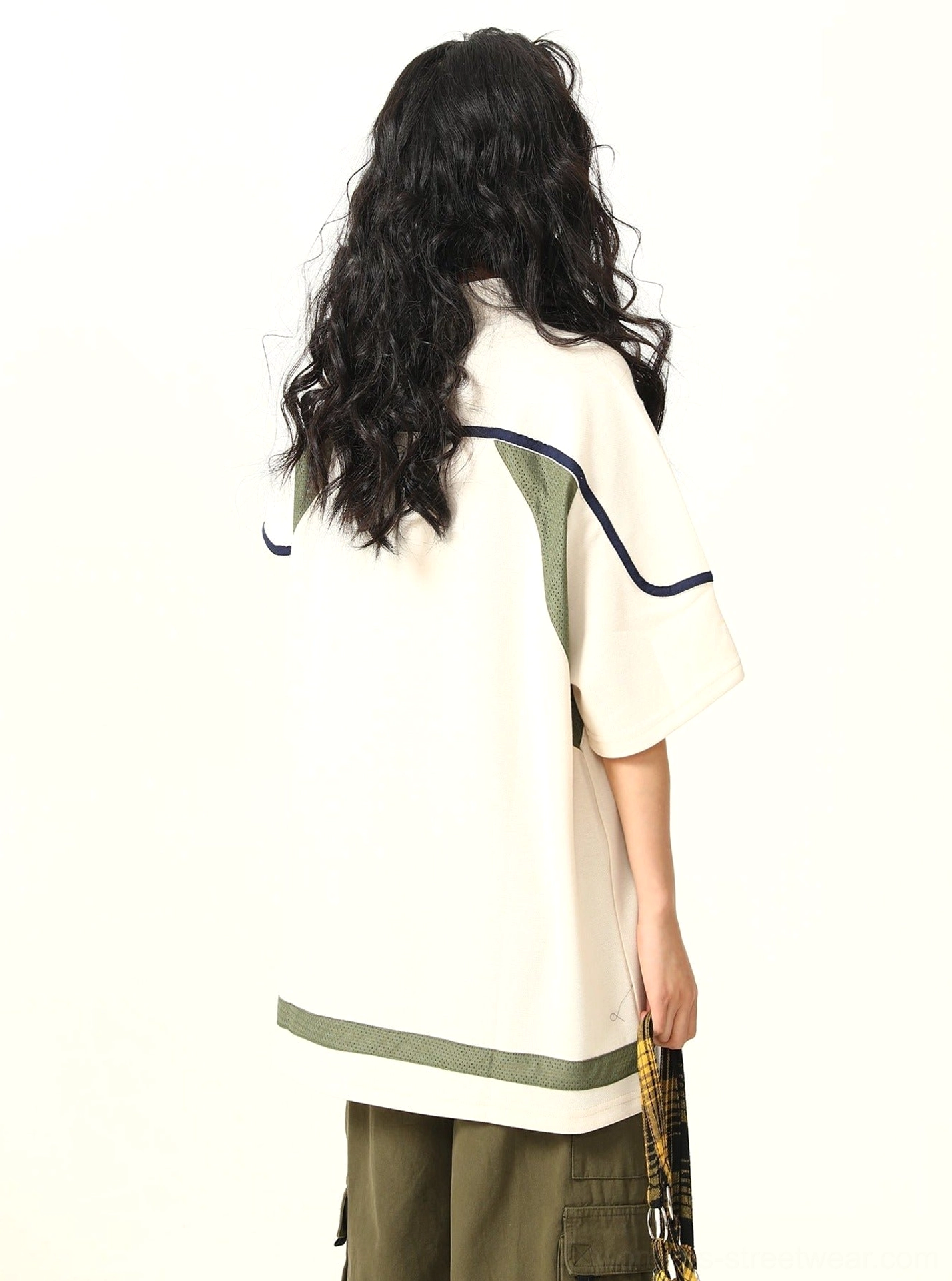 Back view of oversized lace-up collar sports T-shirt showing contrast shoulder and hem stripe details