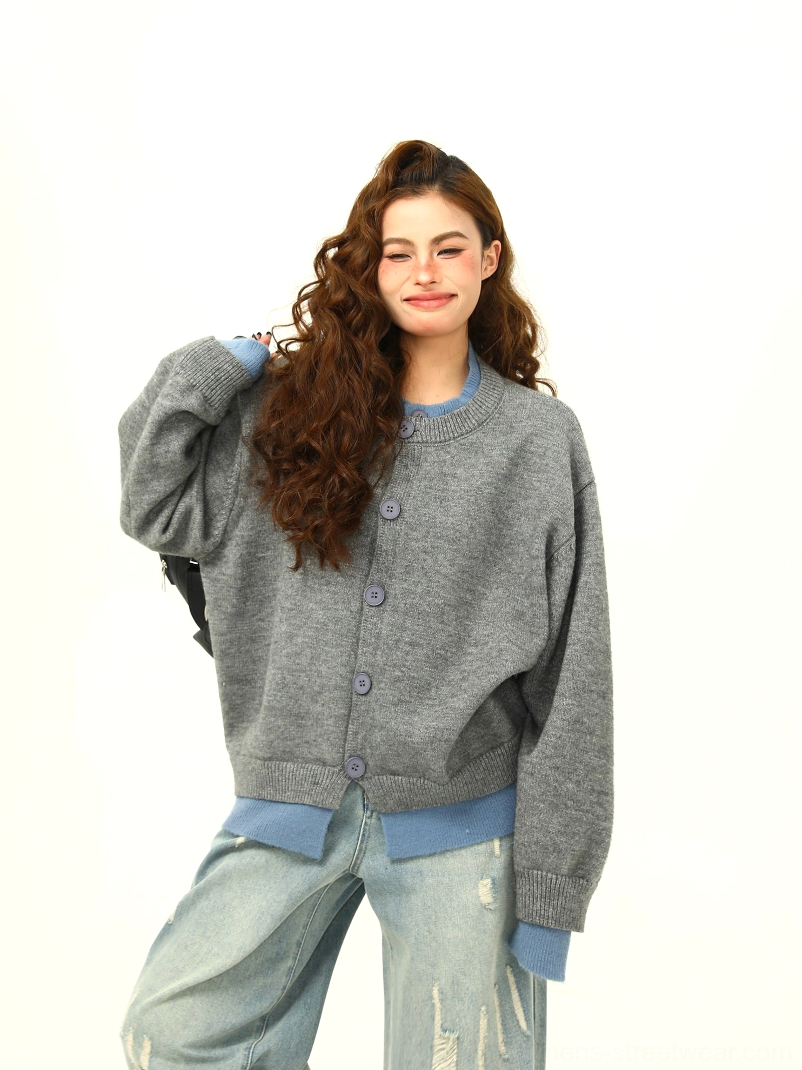Heather grey oversized knit cardigan close and full body view showing blue layered cuffs and contrast hem