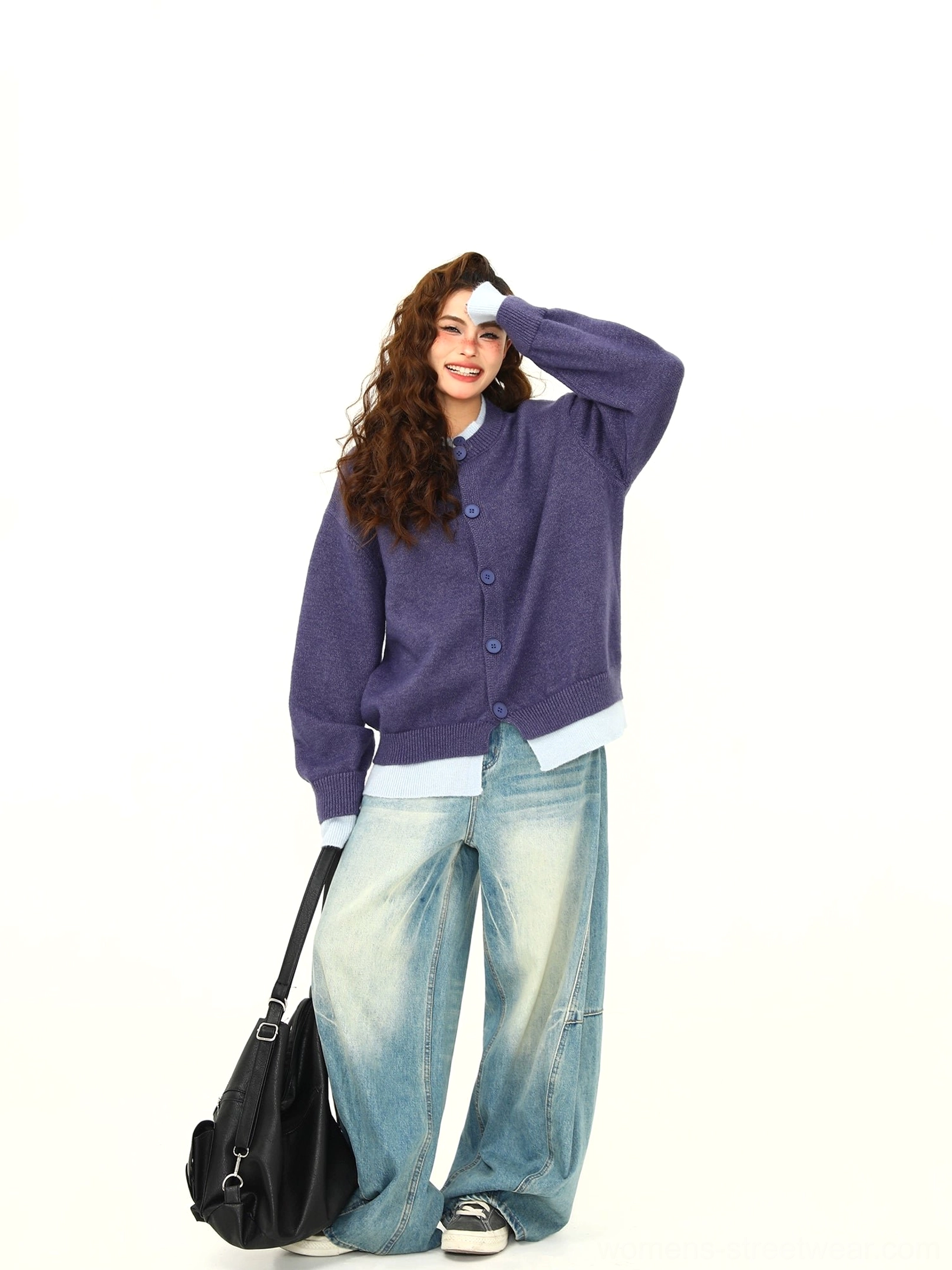 Purple oversized layered hem button knit cardigan styled with light wash wide leg jeans in a studio front view