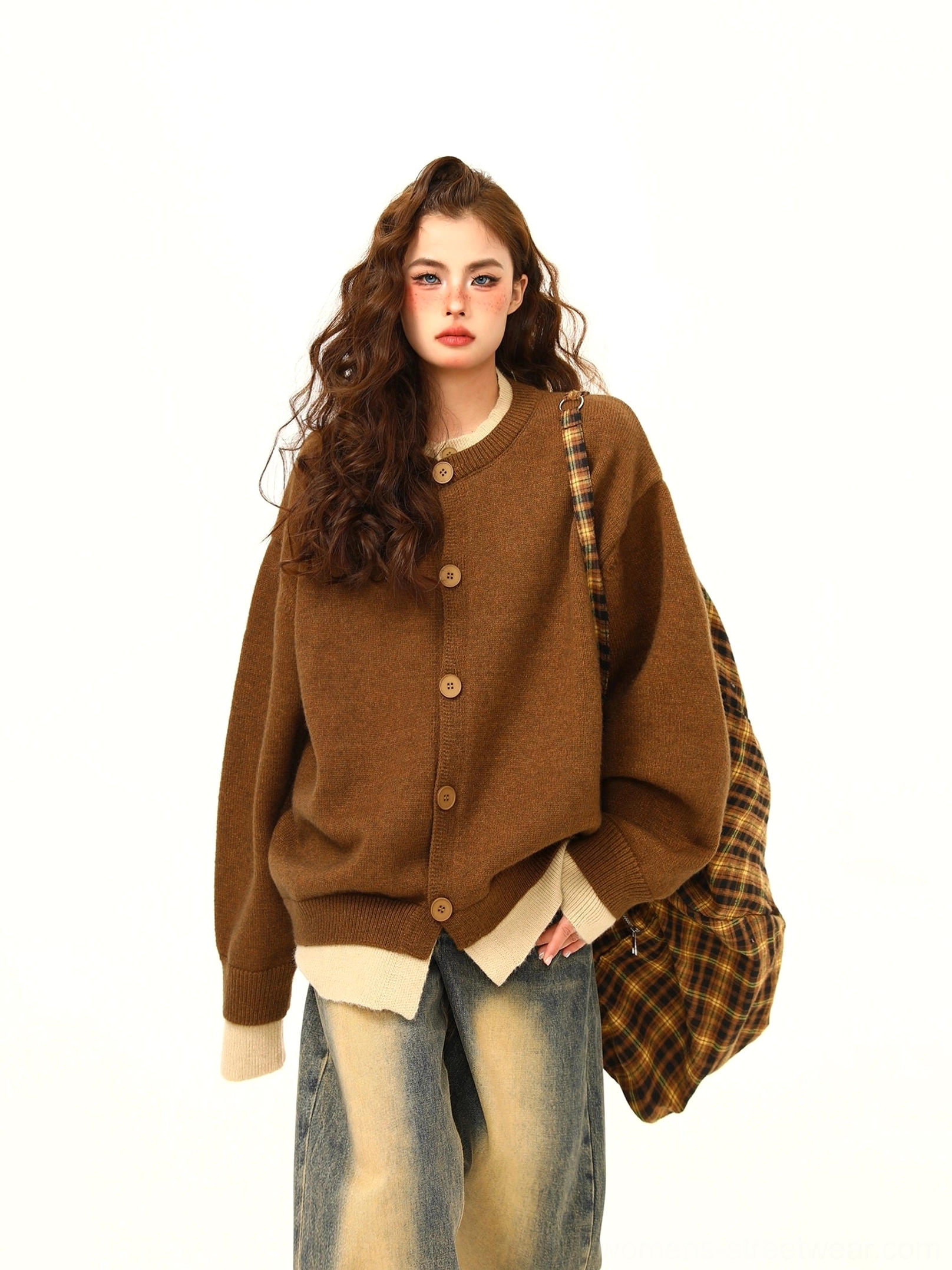 Warm brown oversized layered hem button knit cardigan with beige contrast trim and plaid backpack styling