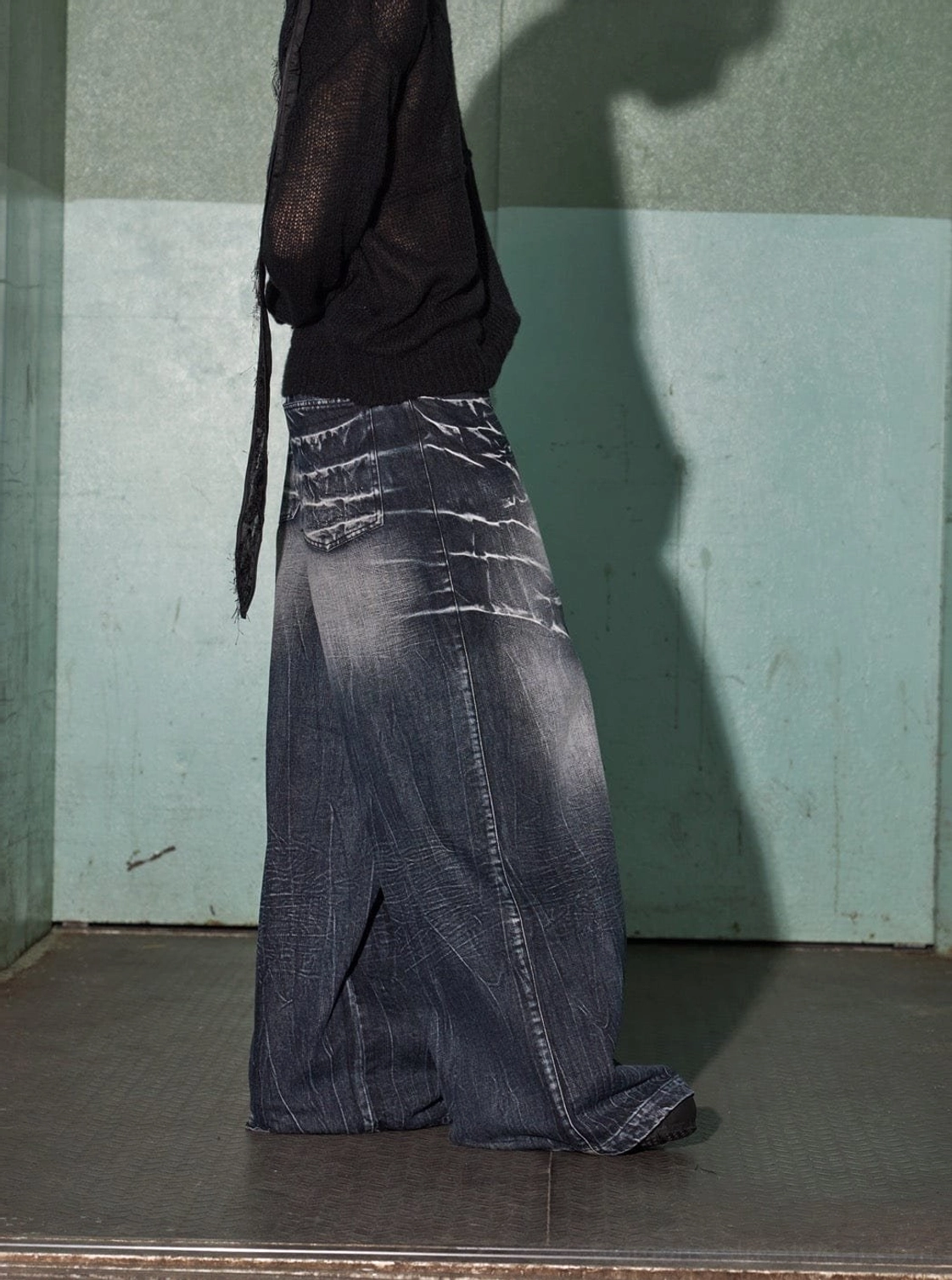 Rear three-quarter view of oversized wide-leg lightning print denim jeans with consistent washed details