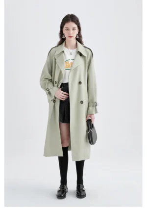 Oversized mid-length sage green trench coat full-body front view on model, relaxed British tailoring streetwear style