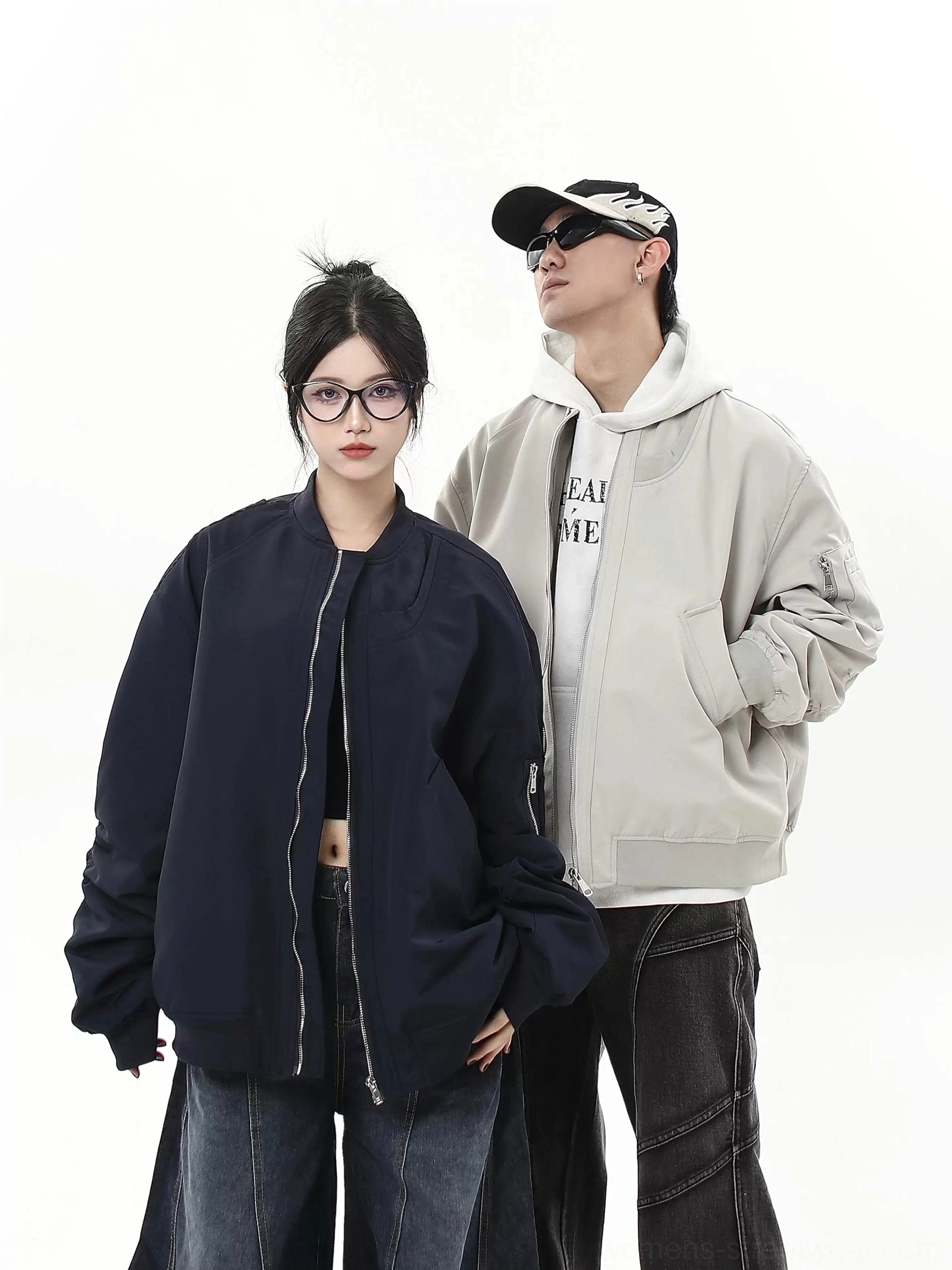 Oversized modular flight bomber jacket in gray and navy shown in a full body studio streetwear group look