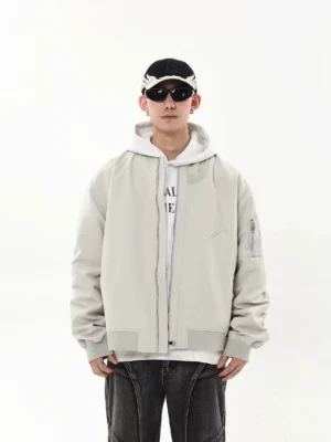 Light gray oversized modular flight bomber jacket front view with ribbed collar and utility sleeve pocket