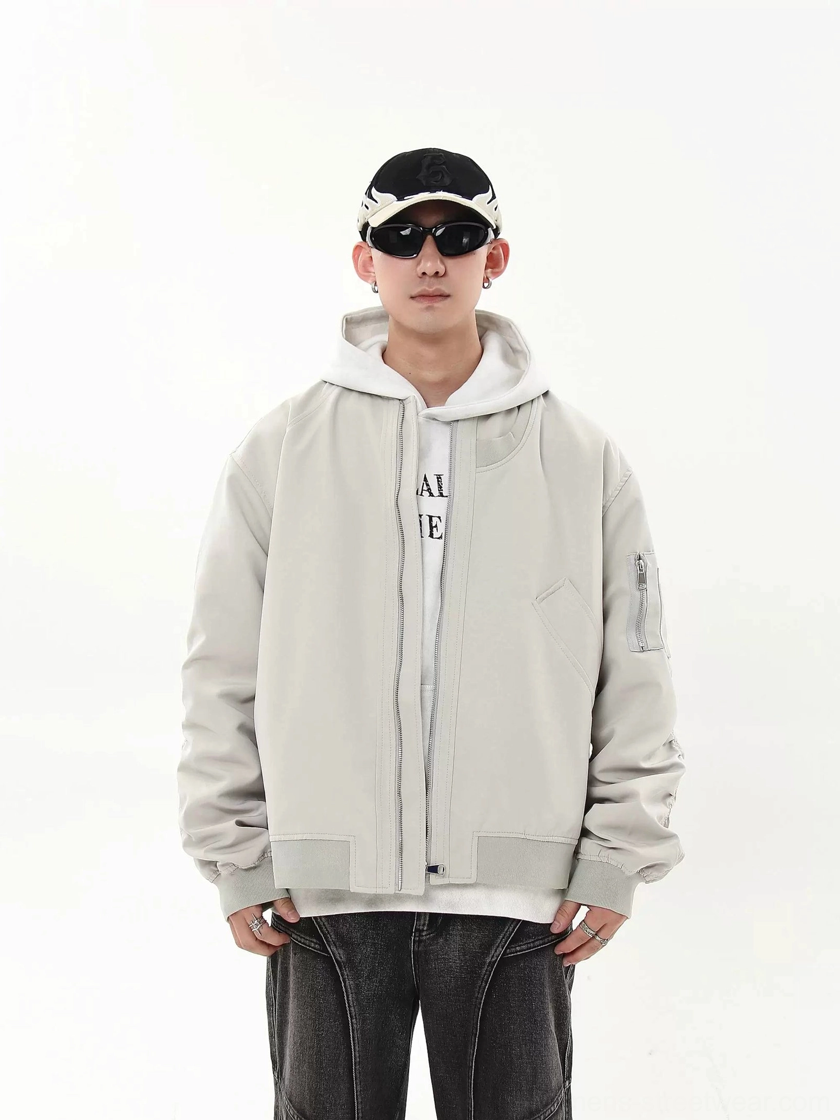 Light gray oversized modular flight bomber jacket front view with ribbed collar and utility sleeve pocket