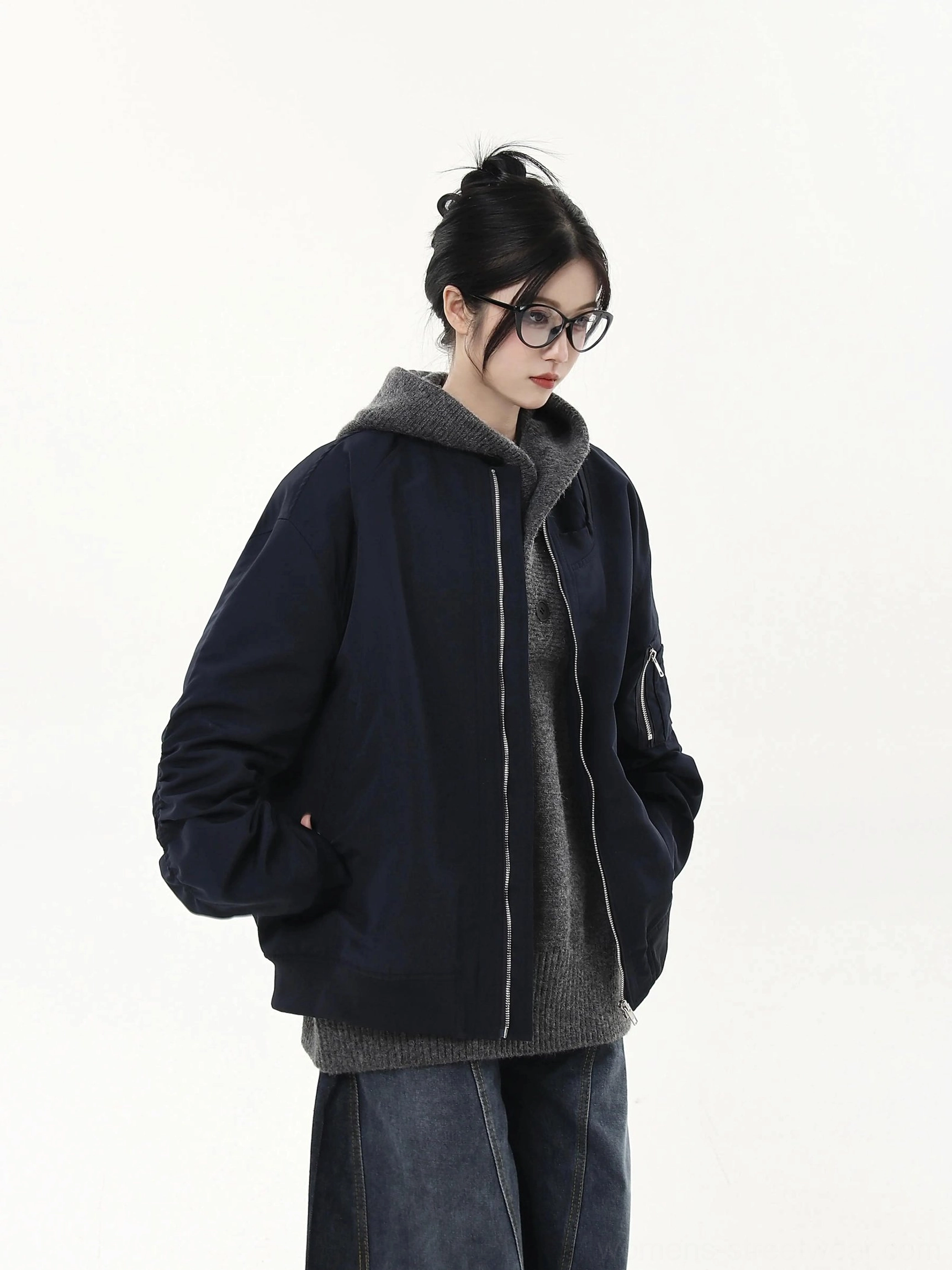 Navy oversized flight bomber jacket worn by female model with front zipper and ribbed hem