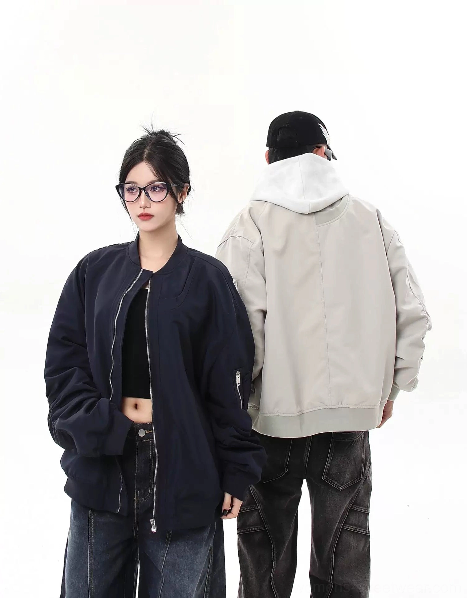 Rear three-quarter view of gray and navy oversized modular bomber jackets with clean back panel construction