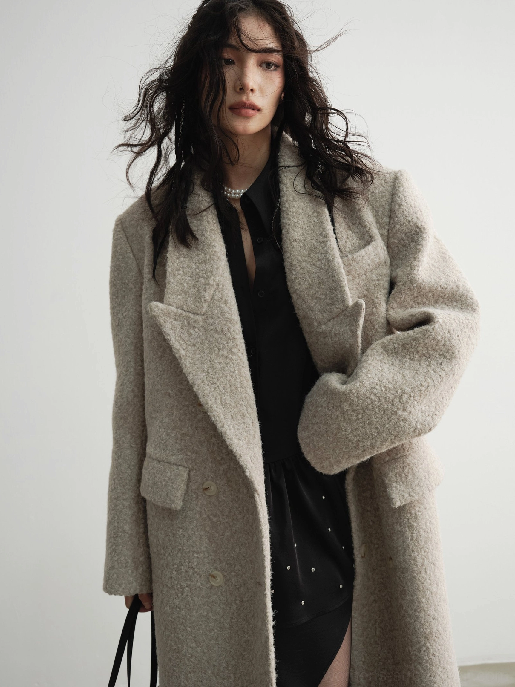 Oversized oatmeal bouclé wool maxi coat styled as a modern avant-garde winter streetwear outerwear piece