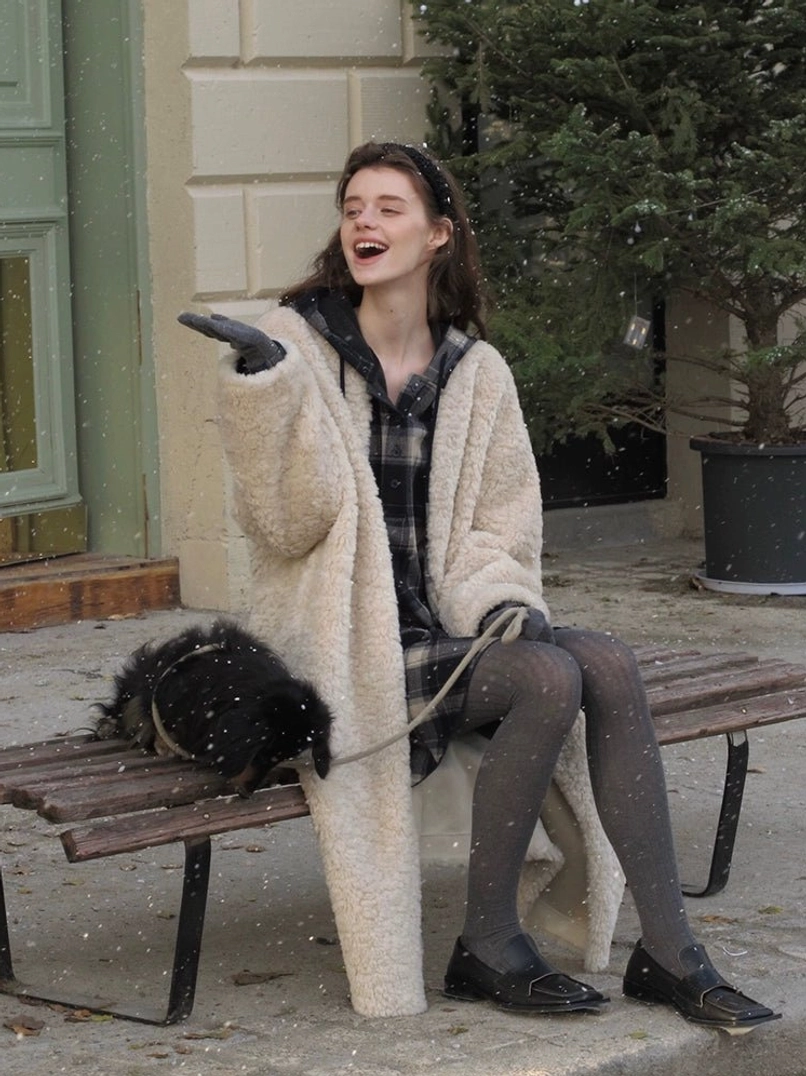 Cocoa Custard oversized open-front faux shearling long coat for women in a three quarter outdoor view