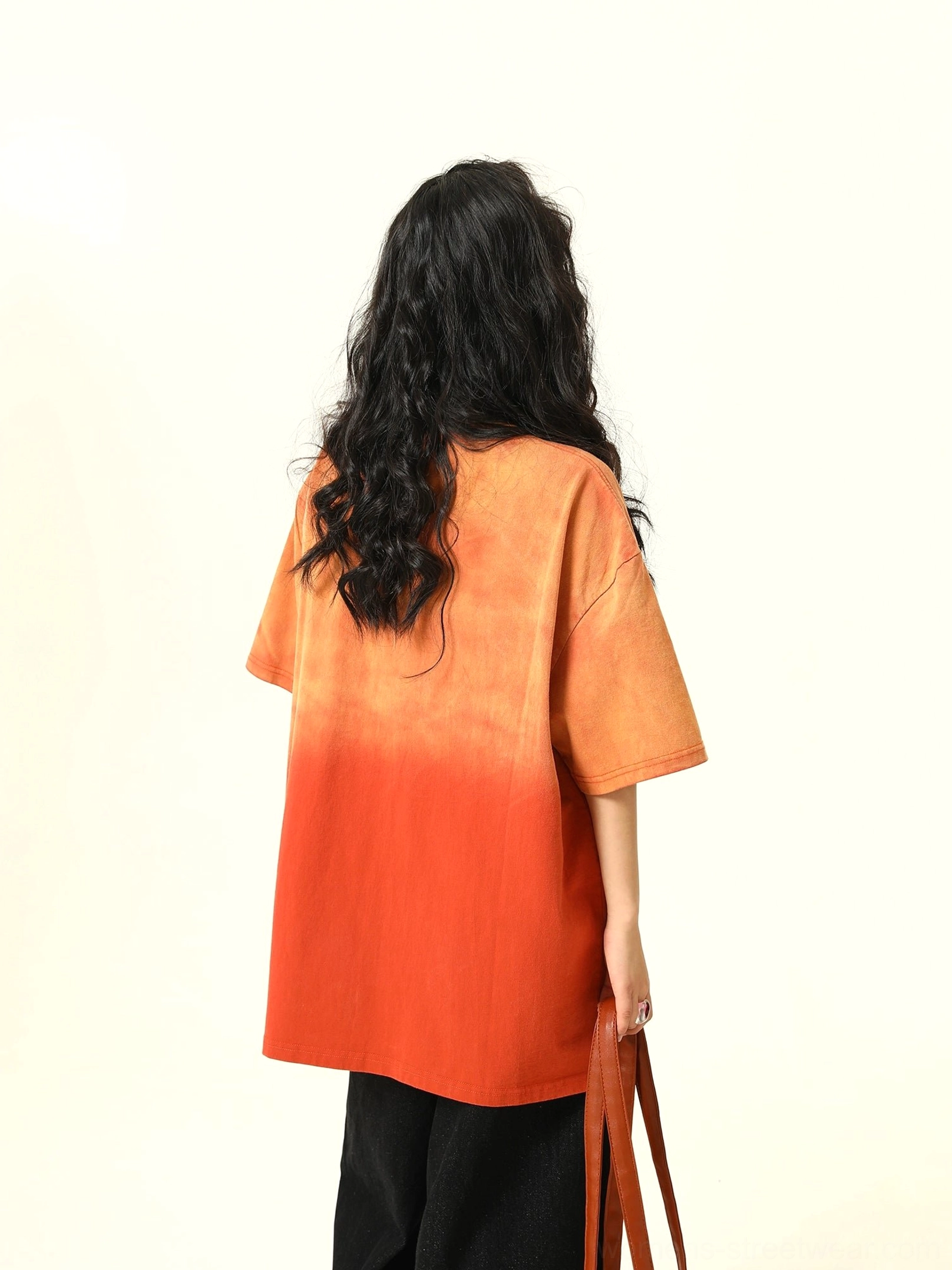 Back view of oversized orange gradient streetwear T-shirt showing clean unprinted back and relaxed silhouette