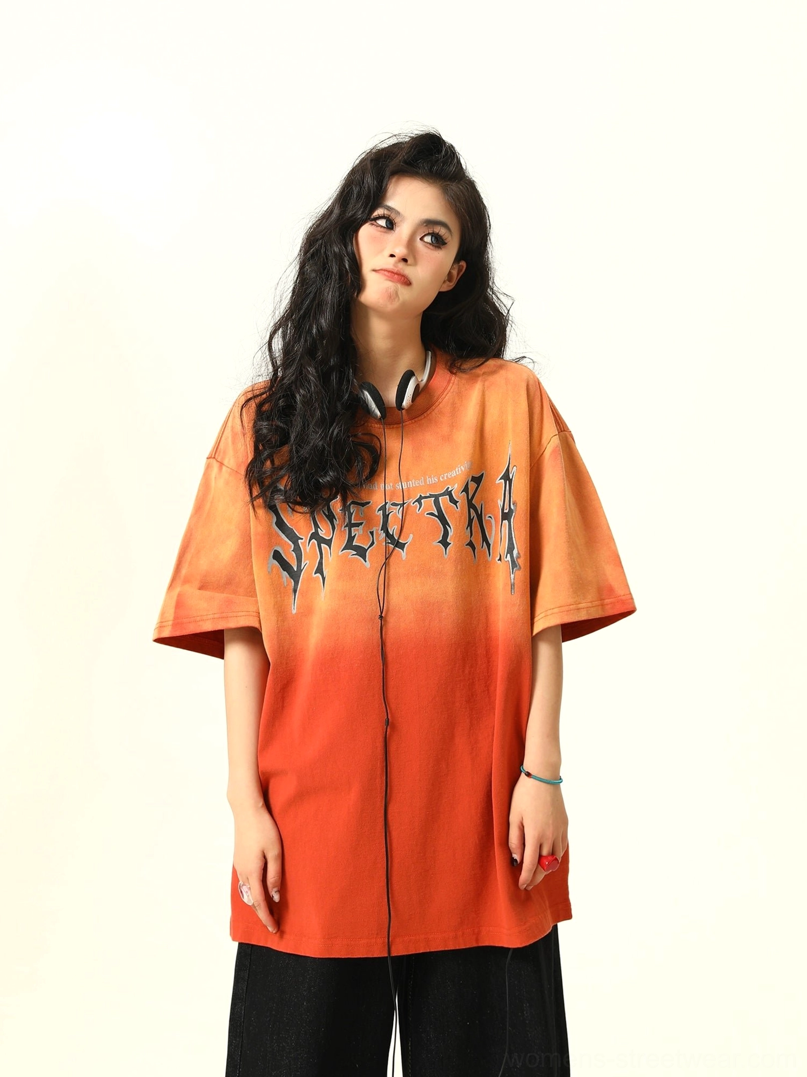 Front close view of orange gradient oversized graphic T-shirt with gothic Spectra lettering and dropped shoulders