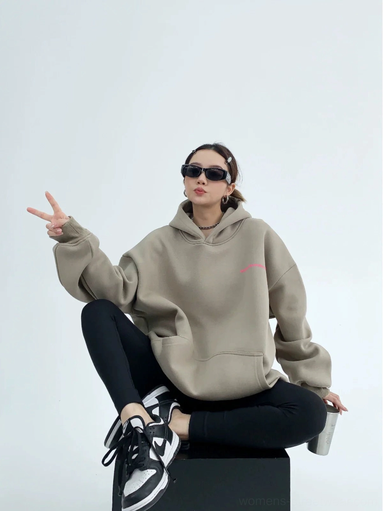 Gray green oversized graphic hoodie front three quarter view with pink chest print kangaroo pocket dropped shoulders and relaxed Korean streetwear fit