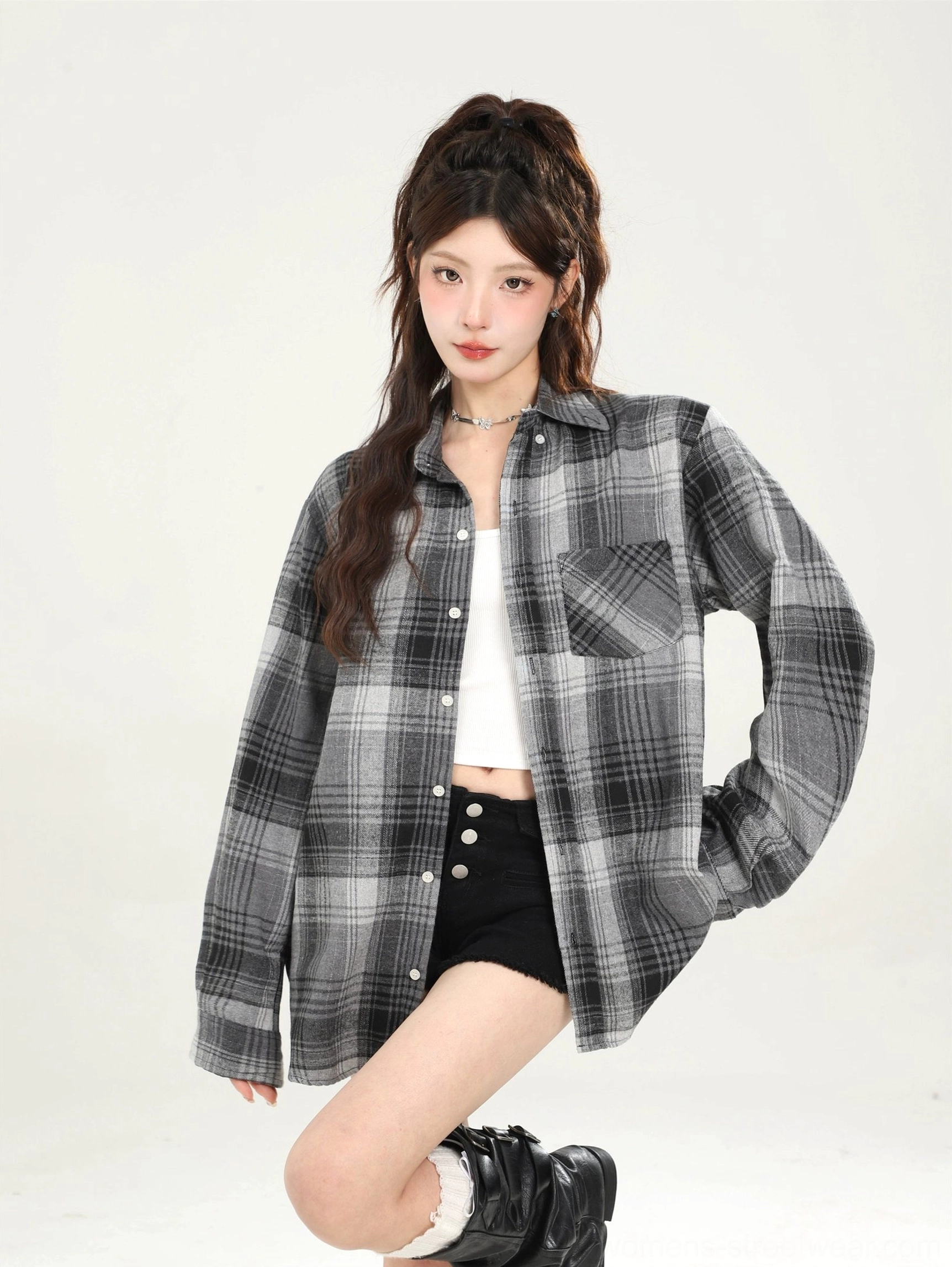 Three-quarter view of black grey plaid loose boyfriend shirt with chest pocket and long sleeves