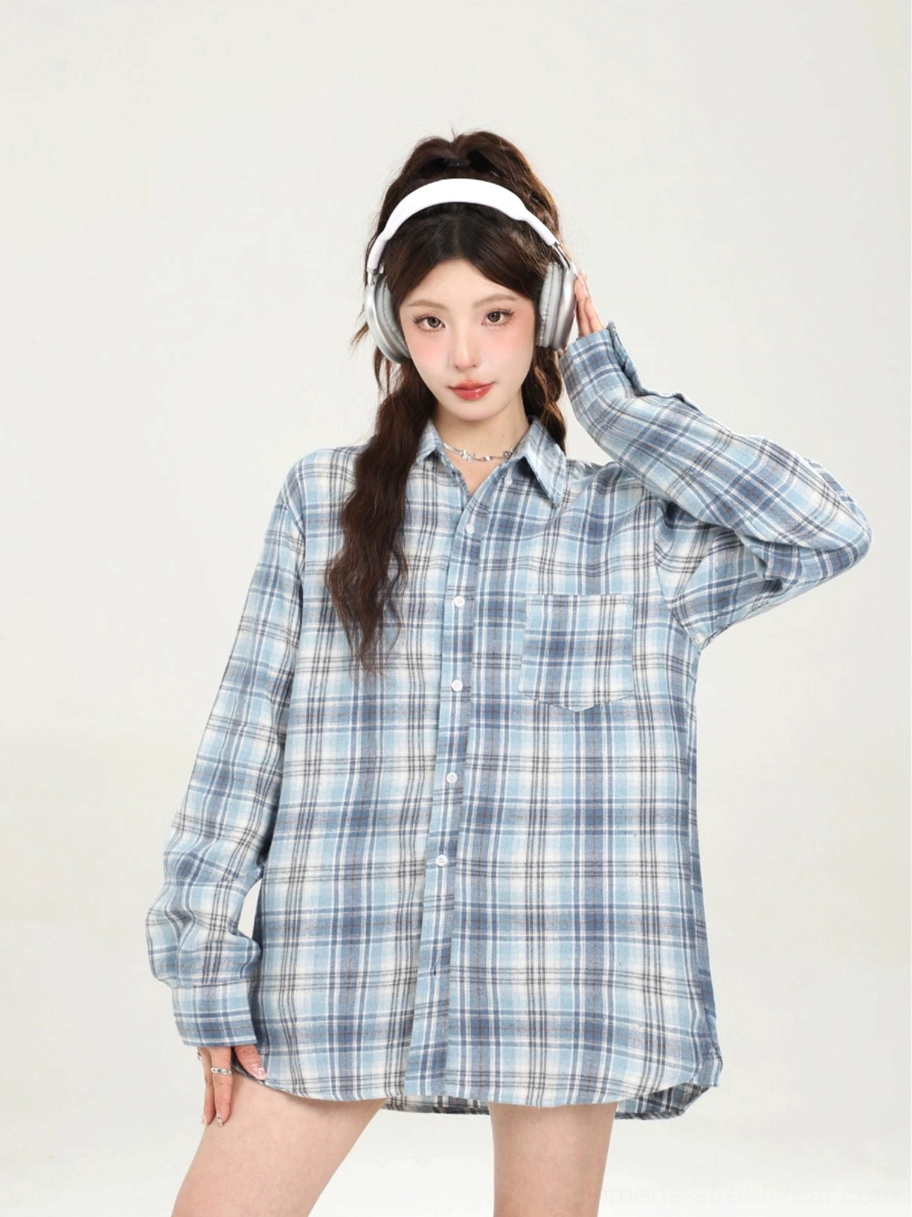 Close front view of blue plaid oversized boyfriend shirt with button placket chest pocket and long sleeves