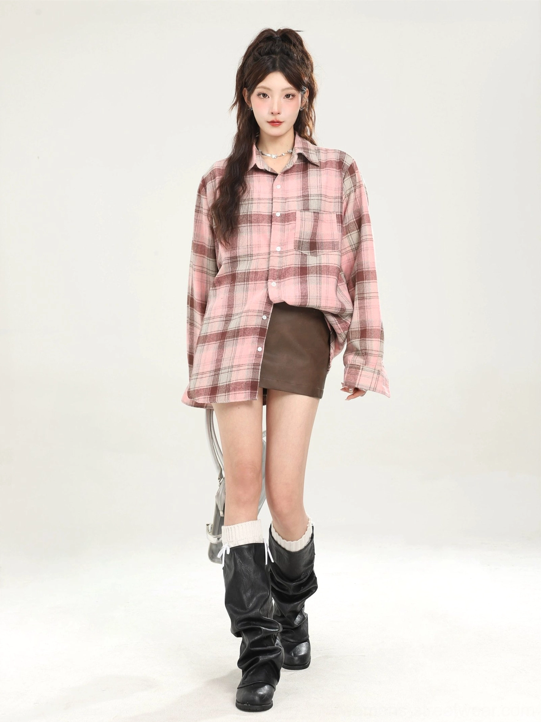 Pink brown plaid oversized boyfriend shirt paired with mini skirt and knee-high boots
