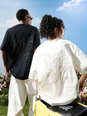 Black and off white oversized puzzle embroidered t-shirts with abstract tonal back graphics in outdoor streetwear styling