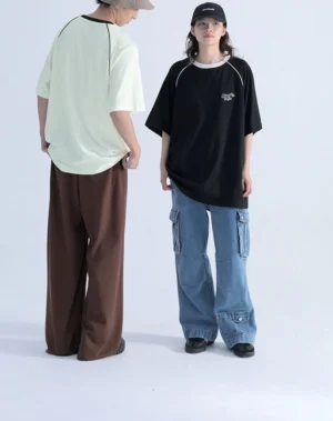 Back view of oversized raglan sleeve streetwear T-shirt showing relaxed silhouette, contrast shoulder seam lines, and clean minimalist construction