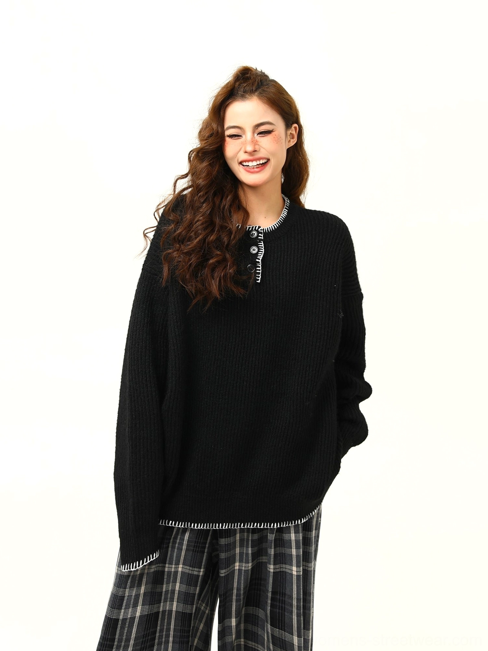 Black oversized ribbed Henley knit sweater with half-button neckline, contrast trim, drop shoulders, and relaxed streetwear fit