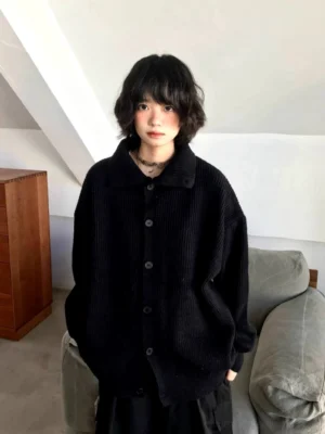 Black oversized ribbed knit cardigan sweater with button front and relaxed Korean streetwear fit shown from the front