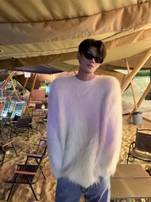 Shaggy faux fur crewneck sweater shown in a relaxed oversized fit at an outdoor beach camp setting