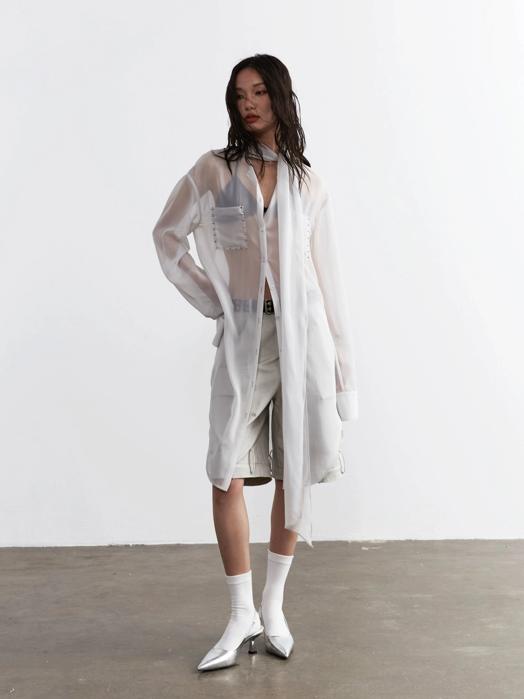 Side view of a light gray oversized sheer blouse with long scarf tie and relaxed streetwear silhouette