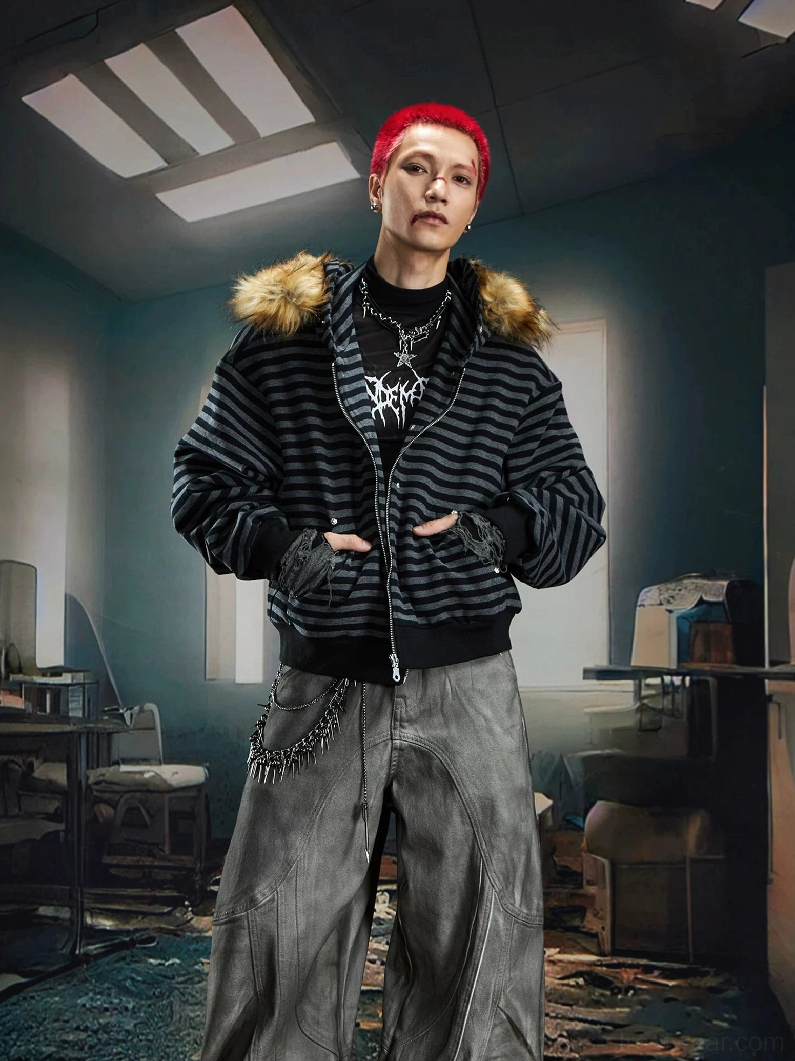 Male model wearing an oversized black and grey striped faux fur hooded jacket with wide-leg denim and chain belt styling