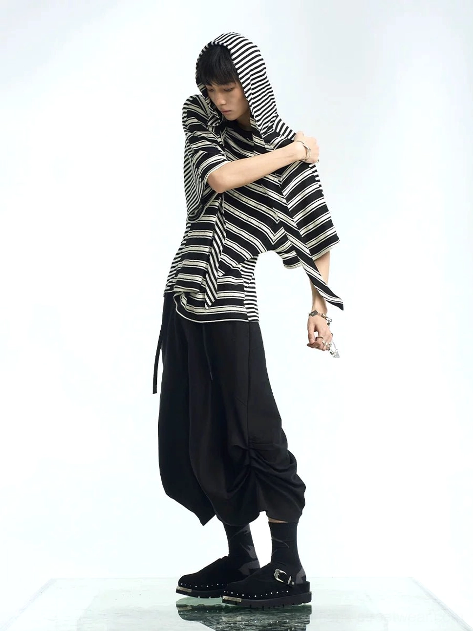 Black and white oversized striped hooded scarf T-shirt side view styled with loose black streetwear pants